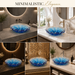 Luxury blue crystal glass table top wash basin with sculpted wavy edges, 420 × 420 × 130 mm, displayed in a modern bathroom.