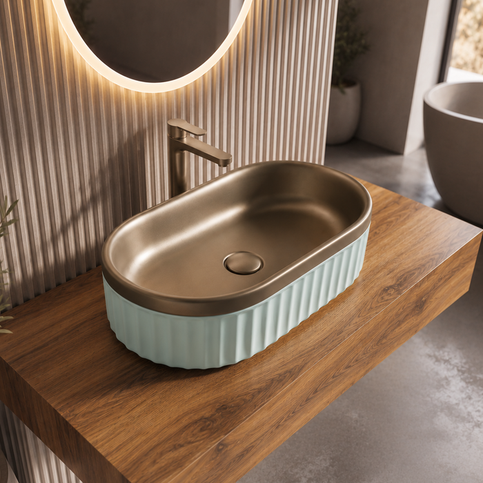 Luxury bronze and white dual-tone table top wash basin with rounded rectangular shape and elegant fluted exterior design for modern bathrooms.