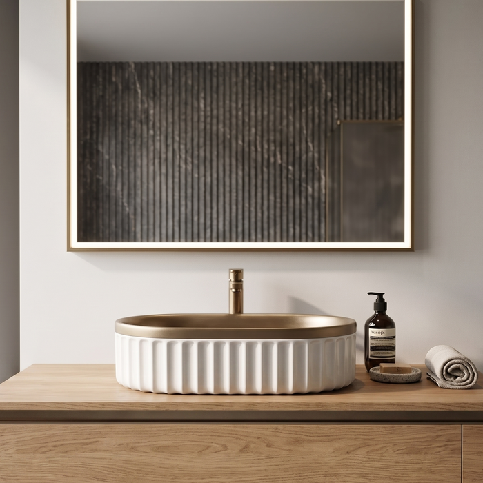 Luxury bronze and white dual-tone table top wash basin with rounded rectangular shape and elegant fluted exterior design for modern bathrooms.