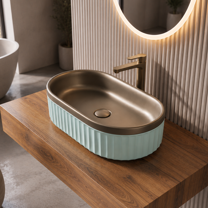 Luxury bronze and white dual-tone table top wash basin with rounded rectangular shape and elegant fluted exterior design for modern bathrooms.