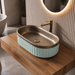 Luxury bronze and white dual-tone table top wash basin with rounded rectangular shape and elegant fluted exterior design for modern bathrooms.