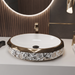 Luxury gold white and black floral oval ceramic table top wash basin 600x400x125 mm with decorative pattern and faceted gold rim.