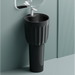 Black freestanding sink with white faucet against a light gray wall.