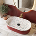 Red ribbed ceramic oval table top wash basin with white multicolour terrazzo finish interior, 600 x 340 x 130 mm, modern countertop bathroom basin