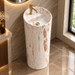 Round freestanding pedestal wash basin 15.4 x 15.4 x 32.7 inch in white and beige marble pattern with cylindrical floor standing design for modern luxury bathroom