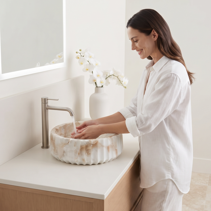 Round white and beige marble-finish table top wash basin with fluted exterior design and 370 × 370 × 135 mm size.