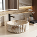 Round white and beige marble-finish table top wash basin with fluted exterior design and 370 × 370 × 135 mm size.