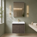 Wall-mounted bronze-grey bathroom vanity set with wave-textured cabinet doors, white basin, mirrored storage cabinet, and integrated LED lighting.
