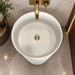 White matte artificial stone freestanding pedestal wash basin with fluted cylindrical design and gold accent, 400×400×860 mm luxury bathroom sink.