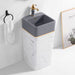 Gray ceramic sink with gold faucet in a bathroom setting, featuring a framed picture of a deer.